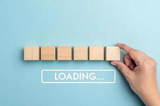 Hand adding last block to loading bar, isolated on blue background photo