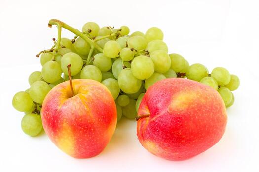 Grapes and an apple on a white background photo