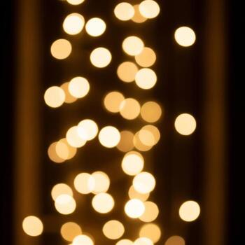 Abstract Bokeh Light String with Golden Circular Blurs on Dark Background photo
