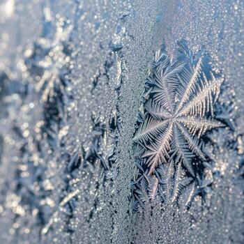 Close Up of Frosted Glass Window with Intricate Snowflake Patterns photo