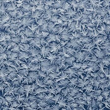 Intricate White Frost Patterns Covering a Deep Blue Surface on a Cold Weather Background photo