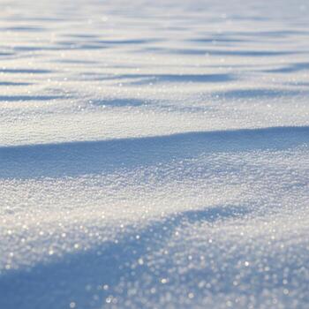 Snowy Field Surface with Sparkling Sunlight and Shadow Patterns in Winter photo