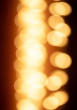 Abstract Warm Light Bokeh with Vertical Alignment and Dark Background for Festive Mood photo