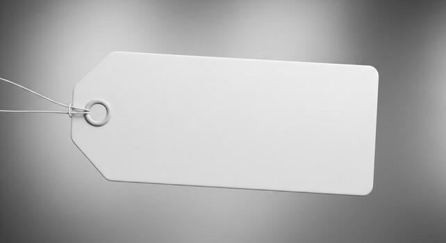 Close up of White Paper Tag with Silver String on Gray Background photo