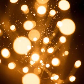 Abstract Warm Orange Bokeh Lights with Sparkling Effect on Dark Background photo