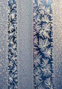 Frosty Pattern on a Window Pane with Cold Texture Close Up in Golden Light photo