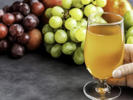 Fresh Fruit Juice with Variety of Grapes and Apples on Dark Background photo