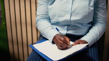 Close up of candidate filling in registration forms for job application and interview, ensuring a great recruitment process and successful meeting with the HR. Writes down qualifications. Camera A. video