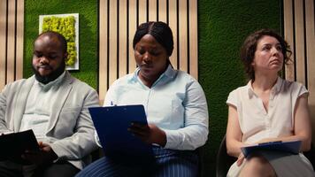 Black candidate filling in registration forms for job application and interview, ensuring a great recruitment process and successful meeting with the HR. Writes down qualifications. Camera A. video