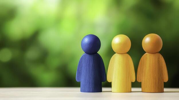 Colorful Wooden Figurines Representing Friendship and Unity Against a Blurred Green Background photo