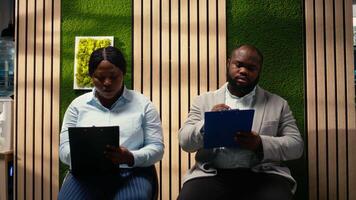 African american applicants filling in registration forms for job interview and open position, ensuring successful recruitment and meeting with the HR. Writing down qualifications. Camera A. video