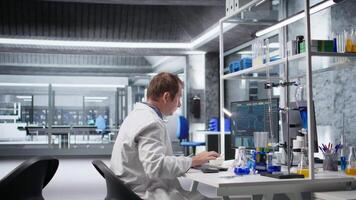 Chemist unable to comprehend results of clinical diagnostics, appears displeased and unsuccessful in laboratory workspace. The hard reality of science and advanced medical research. Camera A. video