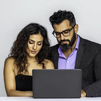Young professionals collaborating on a laptop in a bright modern workspace photo