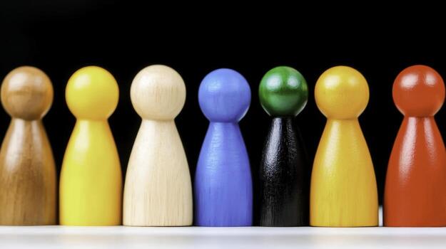 Colorful Wooden Game Pieces in a Row on Black Background for Board Games photo