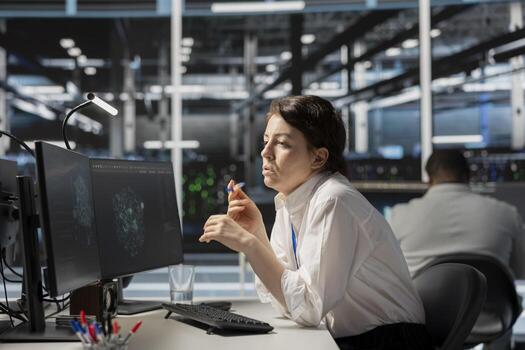 System administrator in data center using AI powered tech to run simulations. Woman at work coding cognitive computing algorithms to extract insights from data and automate rigs photo