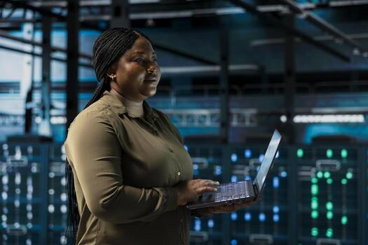 Data center engineer conducting tests on equipment using software to fix bugs. Server farm employee performing updates on infrastructure core services, refining algorithms for faster processing photo