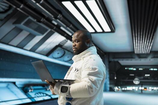 Cosmonaut in spaceship navigating orbital trajectory using laptop, doing galaxy expedition for future of mankind. Astronaut mapping unknown worlds using notebook, exploring extraterrestrial planet photo