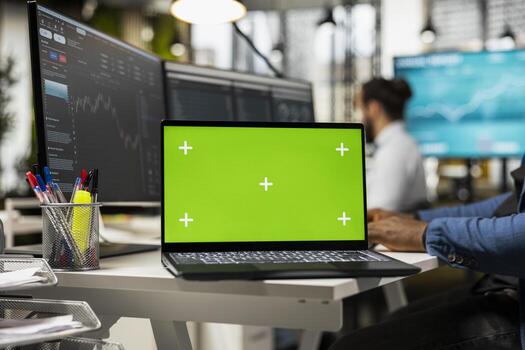 Black advisor managing stock trade progress with chroma key screen, using graphs and trends to monitor the capital from the business account. Young man ensuring development. photo