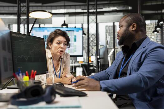 Manager and assistant reviewing monthly data charts to create reports, applying business strategy and analysis to drive innovation and improve company performance. Work alliance. photo