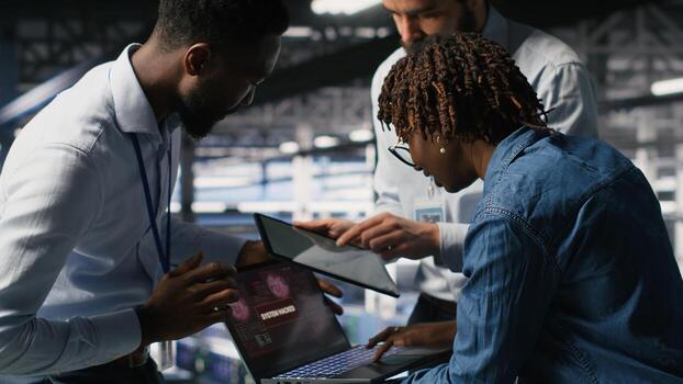 Data center programmer panicking after receiving critical error popup on laptop display. Server farm worker alerted by bugs causing low hardware performance while troubleshooting systems photo