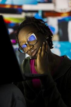 Close up of young woman addicted to watching internet clips, unable to stop using notebook. Lazy teenager staring at laptop display, concept of technology overuse and digital dependence photo
