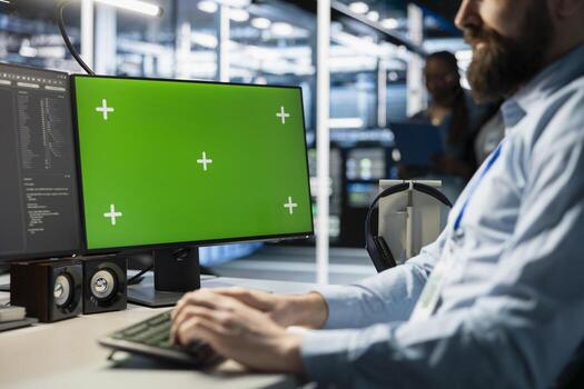 Data center doing software updates on green screen PC, verifying neural network parameters. Server hub IT expert using chroma key PC to inspect configurations, ensuring optimal application performance photo