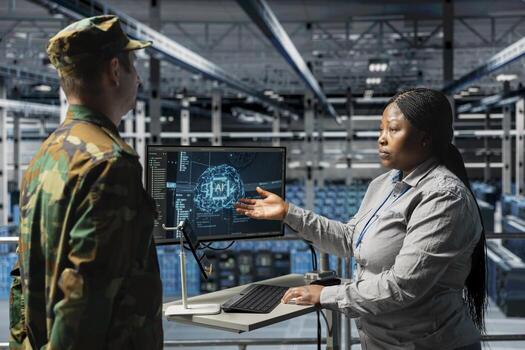 Army tech expert in data center relaying AI battlefield analysis to commanding officer. Server farm workers discussing threat detection results powered by artificial intelligence photo