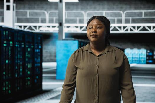 System administrator walking through server farm rows lined with storage infrastructure rigs. IT specialist inspecting high tech data center helping power online services for enterprise customers photo