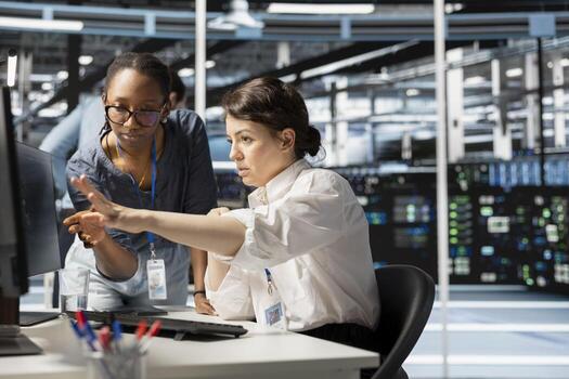 Data center manager supervising engineer implementing technology to improve resource allocation. Server hub supervisor overseeing employee doing predictive maintenance on equipment photo