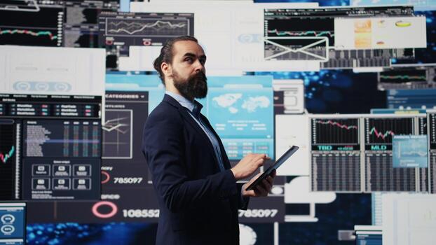 Company administrator searching for a new solution to obtain business growth, working hard for success while he analyzes all reports and KPI metrics. International expansion. Camera B. photo