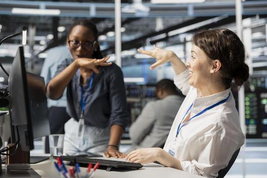 Happy data center colleagues in good mood after after successfully improving system efficiency metrics. Excited engineering team pleased by enhanced network infrastructure performance photo