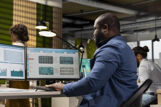 Professional black employee developing a business strategy for growth, leveraging analytics and data to forecast performance. Aligning goals and execute successful management initiatives. photo