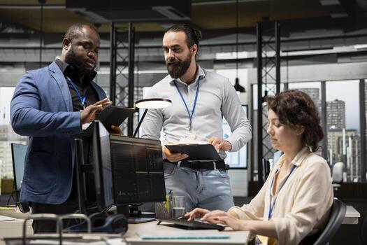 Corporate manager and employees consulting on a new strategy, overseeing performance metrics and collaborative insights to drive project success and organizational growth. Partnership. photo