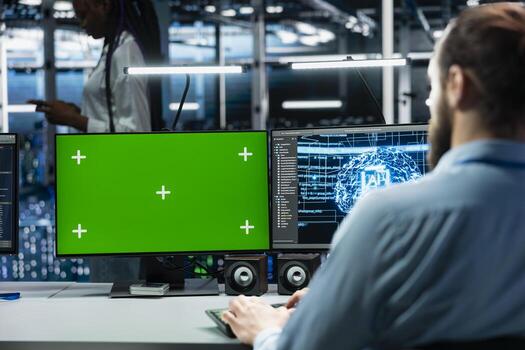 IT expert using green screen PC in server hub with hardware supporting data mining. Computer scientist using chroma key computer in data center to do maintenance on rigs using device photo