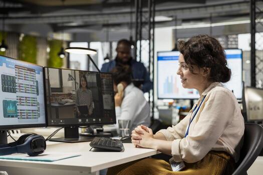 Businesswoman participates at web chat event with a shareholder, sharing insight on performance metrics for a briefing. conferencing in the office between business associates. photo