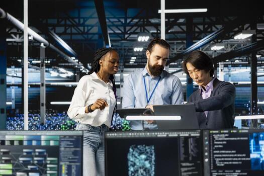 Team of engineers in data center monitoring AI applications, adjusting machine learning. Server hub workers performing load balancing, enhancing artificial intelligence software performance photo