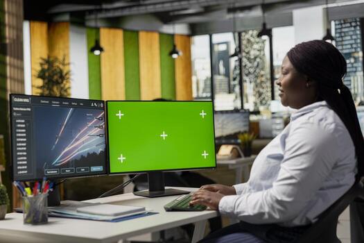 Engineer working for green tech company designs eco power line towers on isolated screen computer. RD expert uses CAD on mockup PC to optimize transmission tower systems, reducing carbon footprint photo