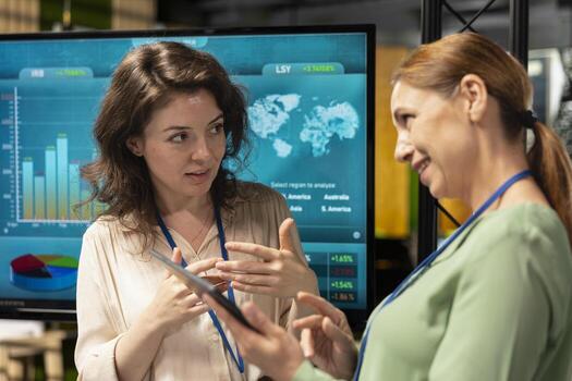 Professional group of female associates analyzing project documents fueled by collaboration and determination, aligning corporate goals to build a unified vision. Networking concept. photo