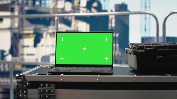 Chroma key tablet on offshore platform with predictive software analyzing rig operations. Green screen mockup device on drilling barge deck managing rig equipment, tracking production efficiency photo