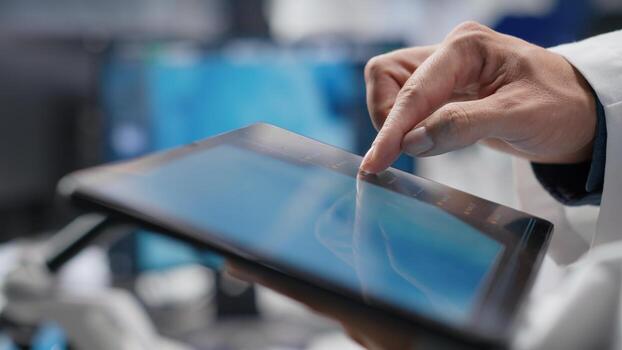 Close up of tablet with modern laboratory software used by scientist for a science experiment, advanced tech. Focused on molecular biology, biotechnology and healthcare innovation. photo