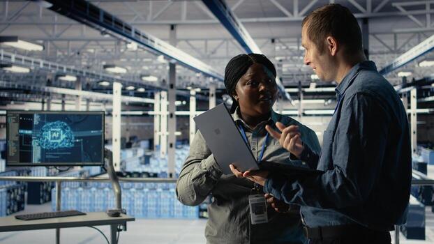 Data center coworkers doing brainstorming, monitoring deep learning processes, reviewing operational metrics. Colleagues working together to review neural networks reports during inspection, camera A photo