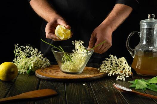 Adding lemon manually to a glass container with elderberries before making a cold drink or kvass. The concept of making a medicinal drink based on folk recipes photo