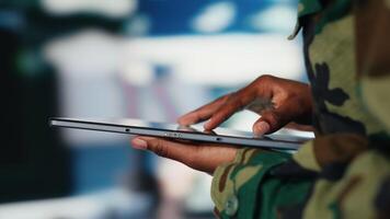 Close up of army soldier using tablet radar software to track hostile threats. African american woman in command center using target acquisition tech on device to detect enemy location video