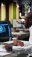 Vertical Black man analyst uses AI neural networks for data mining and optimization, working in a multinational company with automation tools. Artificial intelligence digital tools for success. Camera A. video