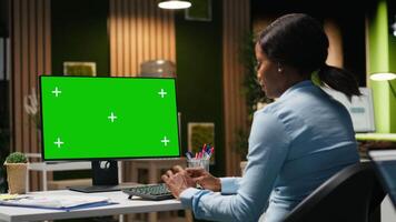 Isolated chroma key on desktop pc with black analyst analyzing KPI metrics, applying a strategic mindset to business development plans. Support innovation and goals achievement. Camera B. video