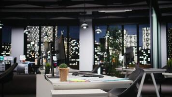Empty modern workspace at night with infographics and pc devices at workstation, business office used for company management and administration. Digital tools for forecasting. video