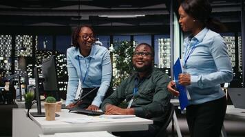 team av svart kollegor håller på med lagarbete på en projekt med finansiell prognoser, utskjutande data till bygga ut de företag aktivitet och vinst. lagarbete i arbetsyta till säkerställa mål. kamera a. video