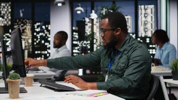 Male consultant engaged in handwriting notes for monthly reports, extracting essential highlights from finance documents and making a summary for business goals and upcoming tasks. Camera B. video