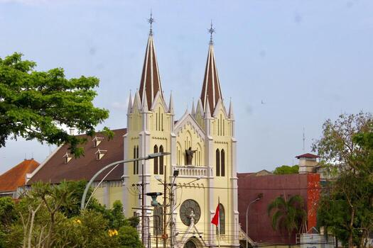 Malang, East Java, Indonesia - September 17, 2025 A historic church with twin towers and Gothic style architecture, captured in an urban setting under a clear sky. photo