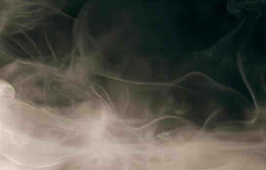 Soft smoky fog swirling on a dark background, creating a moody and atmospheric texture ideal for overlays, horror scenes, dreamlike visuals, or cinematic graphic design compositions. photo